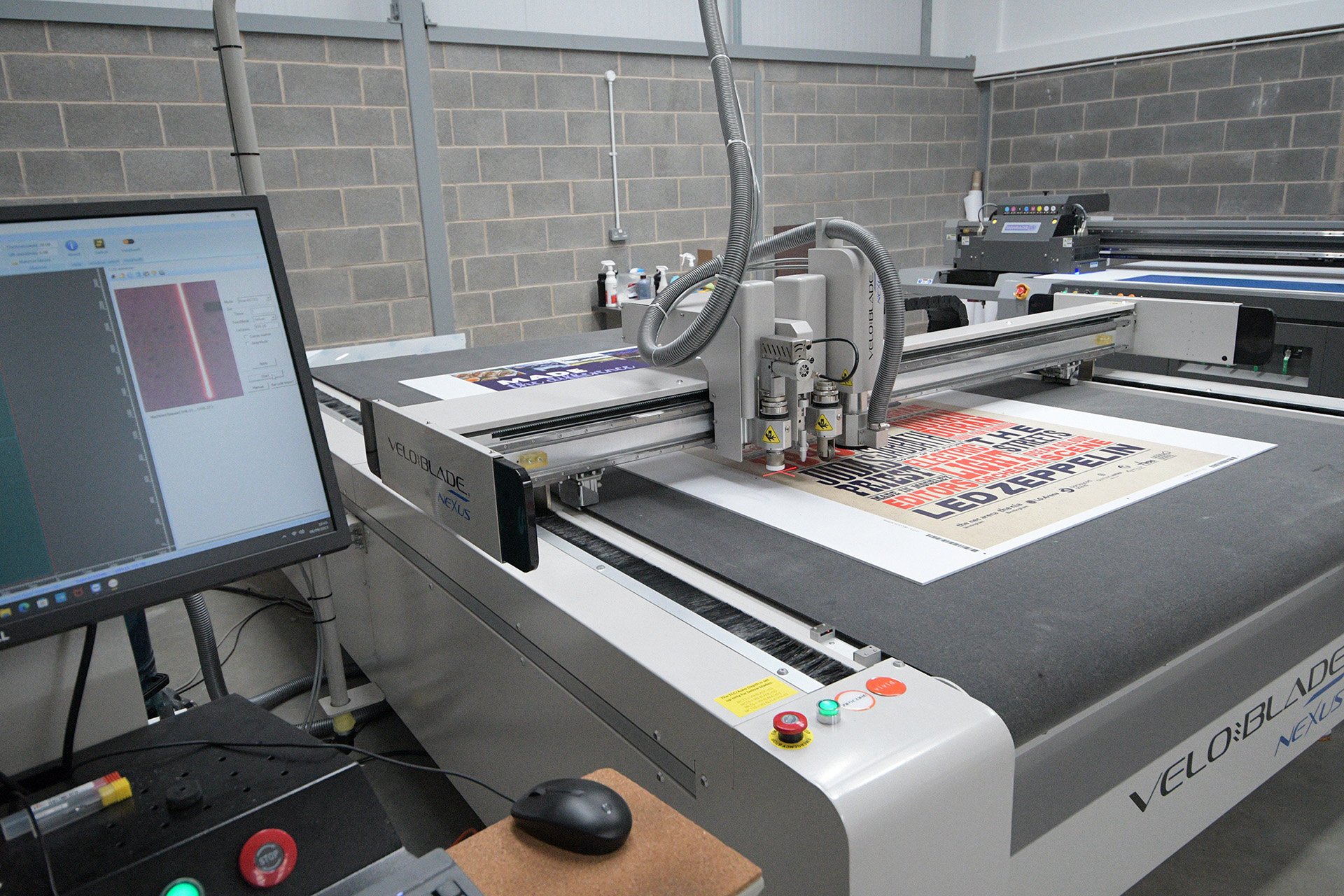 A piece of print being trimmed on a professional guillotine